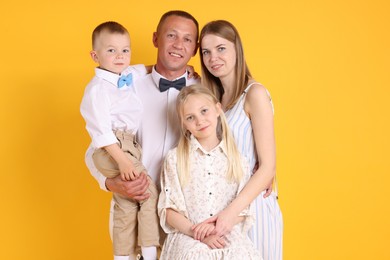 Photo of Family portrait of parents and their children on yellow background