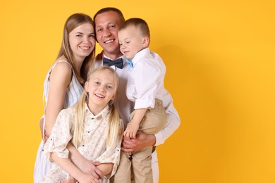 Photo of Happy family on yellow background. Space for text