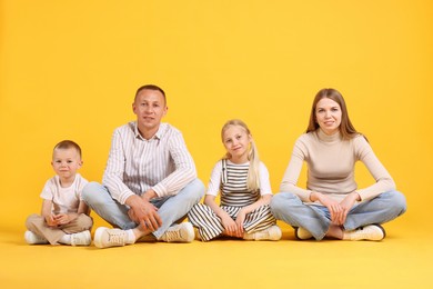 Photo of Full length portrait of cute family on yellow background