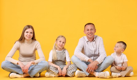Photo of Full length portrait of happy family on yellow background