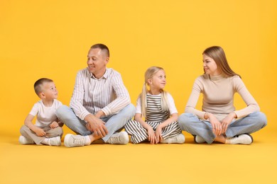 Photo of Full length portrait of happy family on yellow background