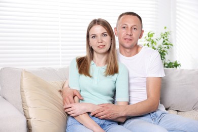 Photo of Portrait of lovely couple on sofa at home