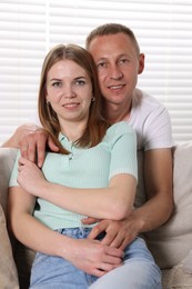 Photo of Portrait of happy lovely couple at home