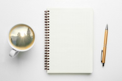 Image of Cup with mountain landscape on sunny morning inside. Empty notebook, pen and cup on white table, top view