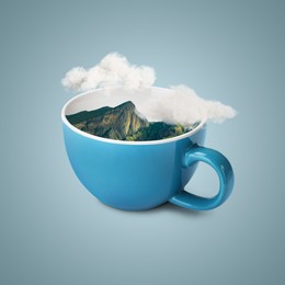 Image of Clouds above mountains in cup against light greyish blue background