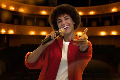 Image of Beautiful woman singing on stage in concert hall