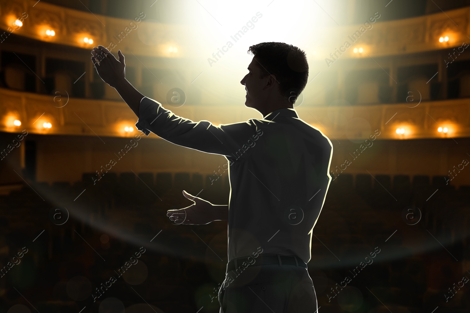Image of Man performing on stage in concert hall