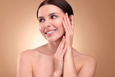 Image of Beautiful woman with perfect skin after collagen treatment on light brown gradient background. Arrows on her face illustrating lifting and smoothing effect