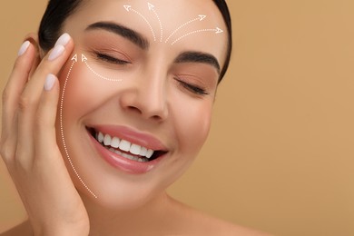 Image of Beautiful woman with perfect skin after collagen treatment on dark beige background, space for text. Arrows on her face illustrating lifting and smoothing effect