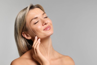 Image of Beautiful woman with perfect skin after collagen treatment on grey background, space for text. Lines on her face illustrating lifting and smoothing effect