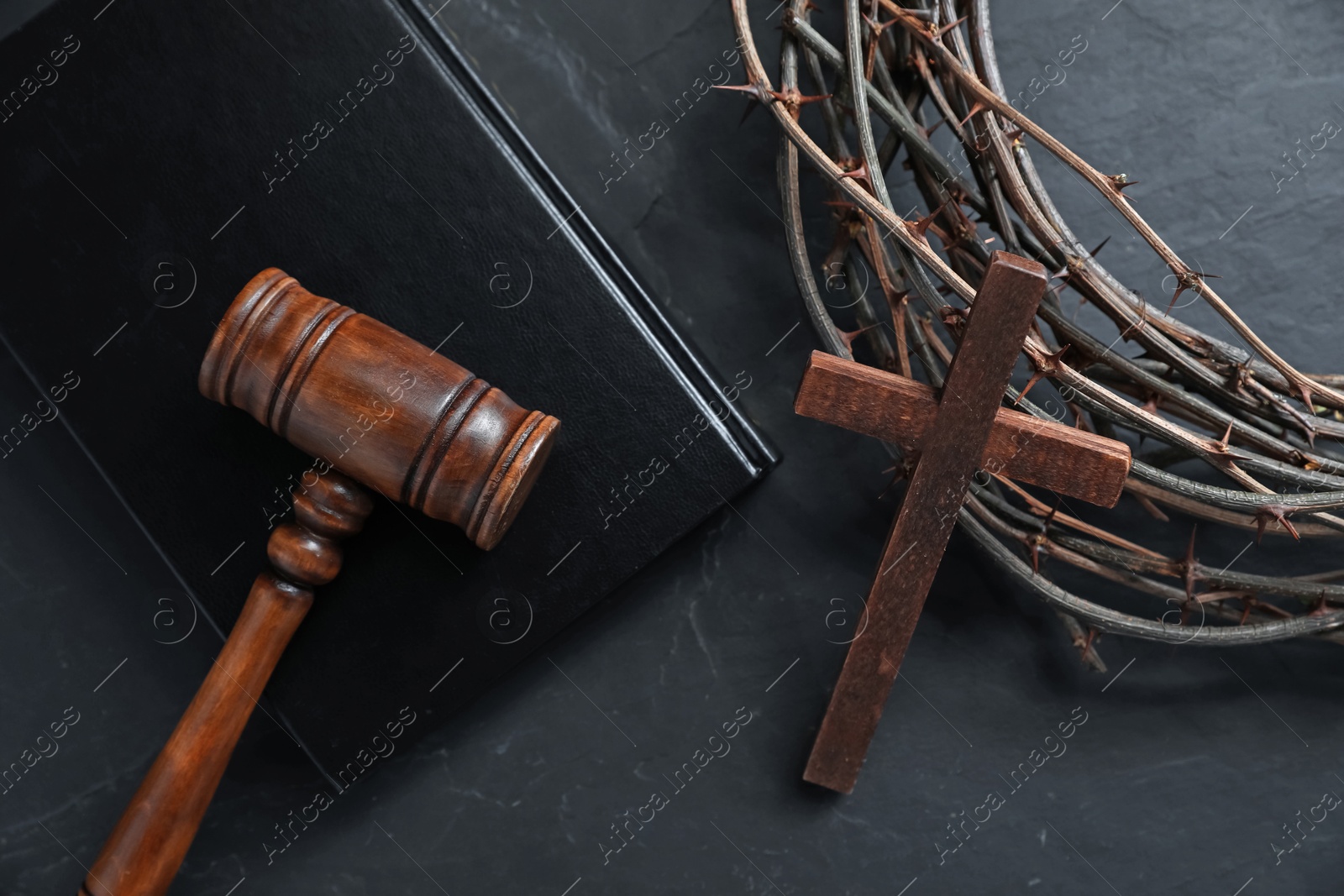 Judge's gavel, crown of thorns, Bible and wooden cross on black table, flat lay Photo of Judge's gavel, crown of thorns, Bible and wooden cross on black table, flat lay
