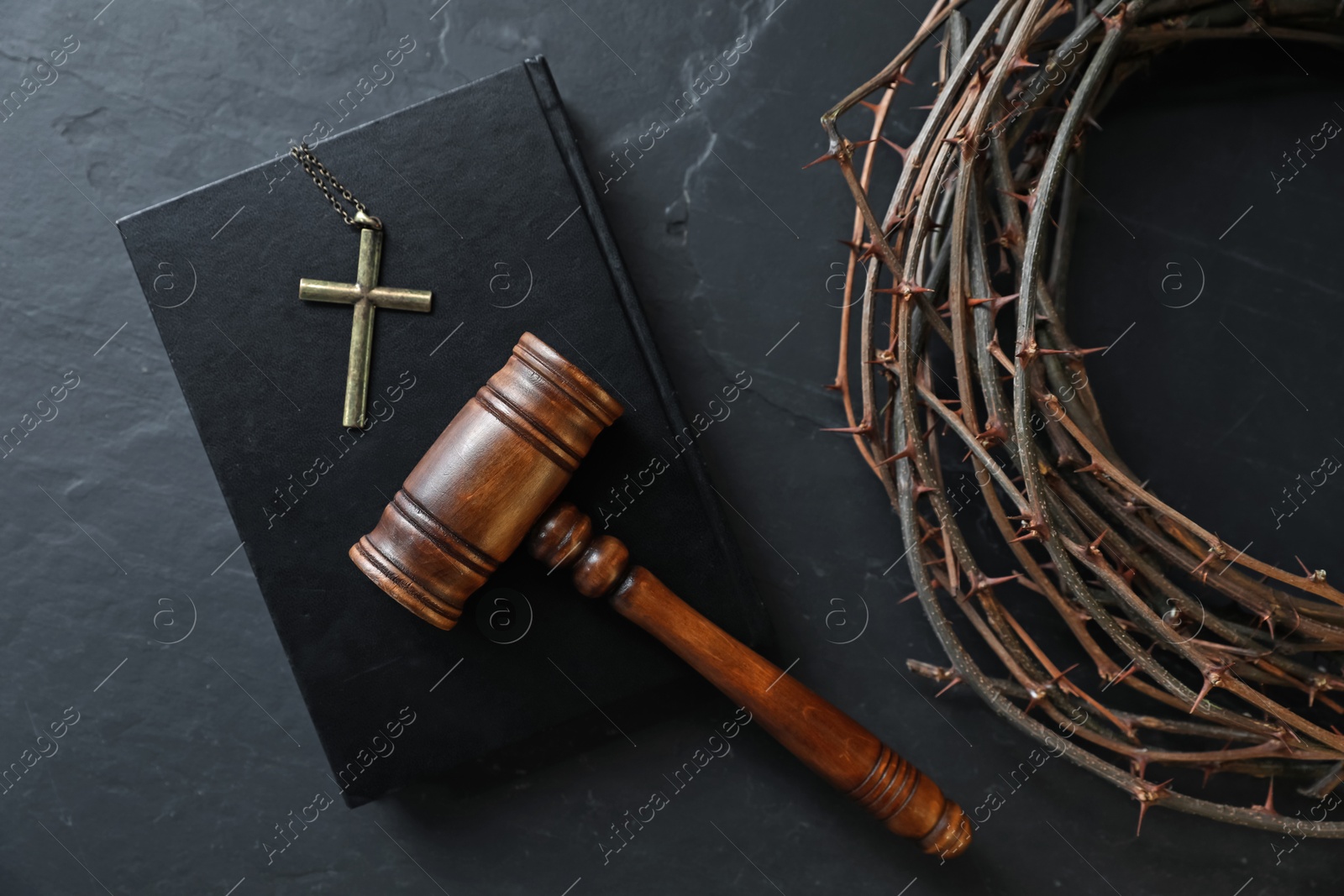 Judge's gavel, crown of thorns, Bible and cross on black table, flat lay Photo of Judge's gavel, crown of thorns, Bible and cross on black table, flat lay