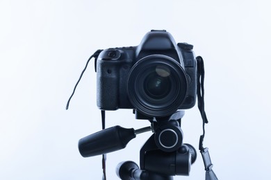 Photo of Modern professional video camera on white background