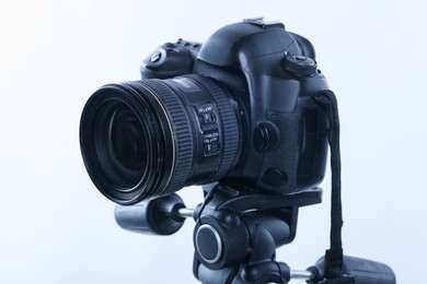 Photo of Modern professional video camera on white background, closeup