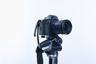 Photo of Modern professional video camera on white background