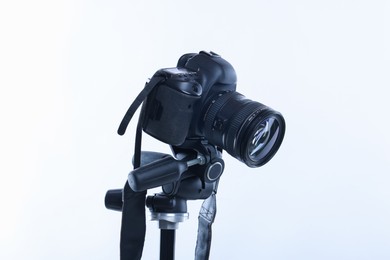 Photo of Modern professional video camera on white background