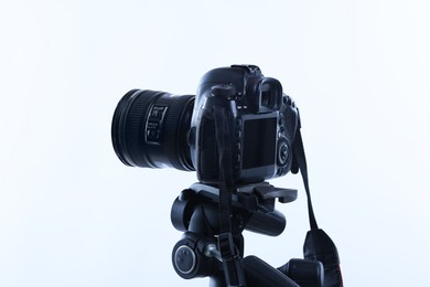 Photo of Modern professional video camera on white background