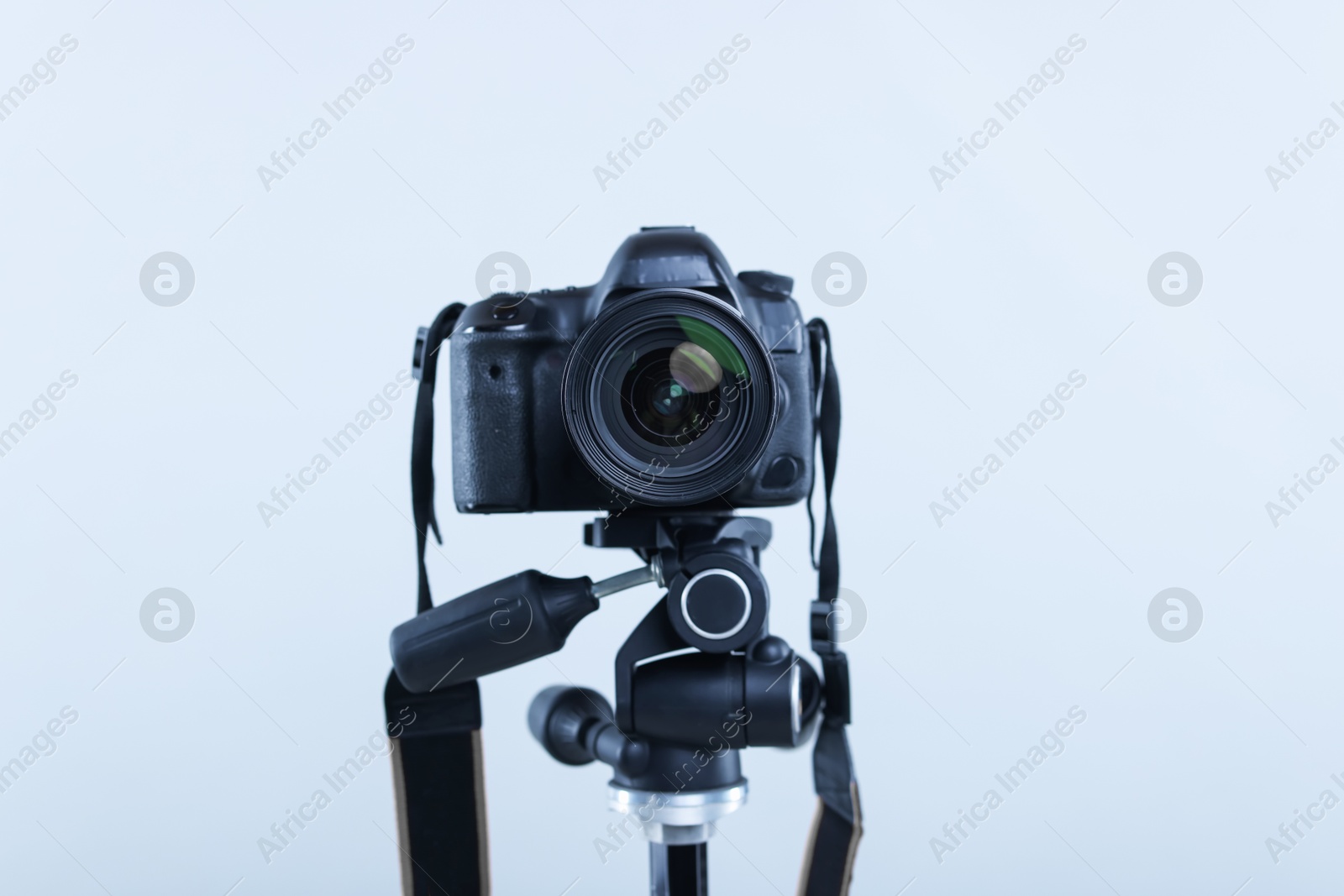 Modern professional video camera on light grey background, closeup Photo of Modern professional video camera on light grey background, closeup