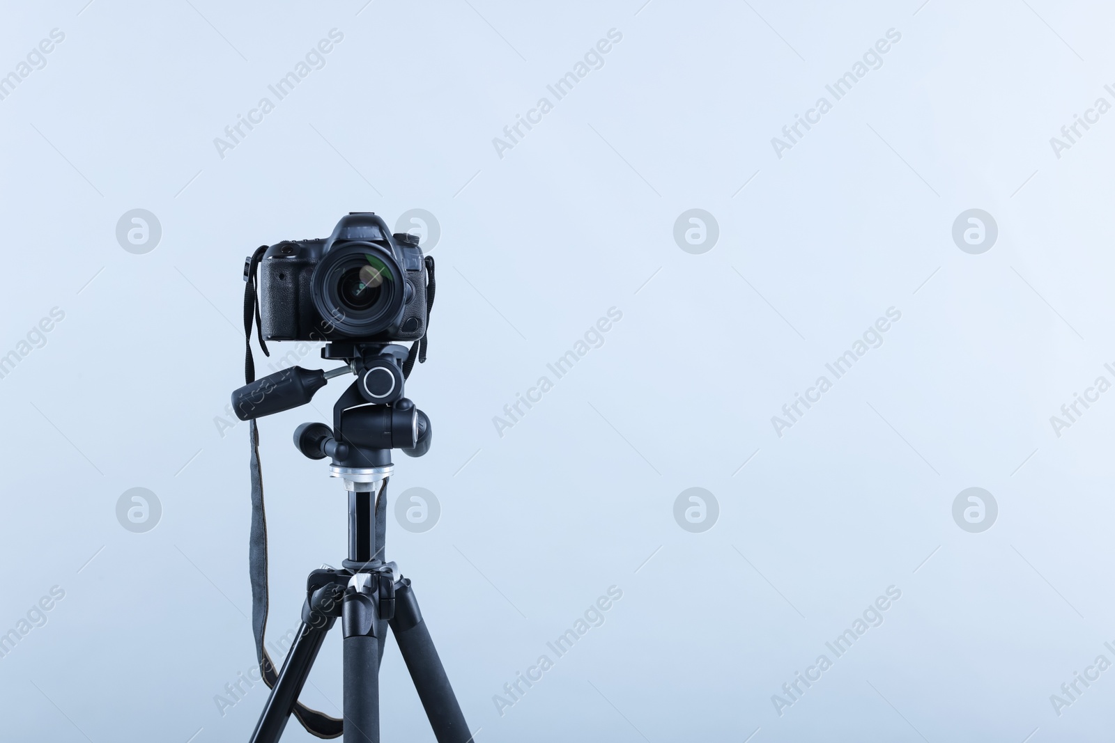 Modern professional video camera on light grey background, space for text Photo of Modern professional video camera on light grey background, space for text