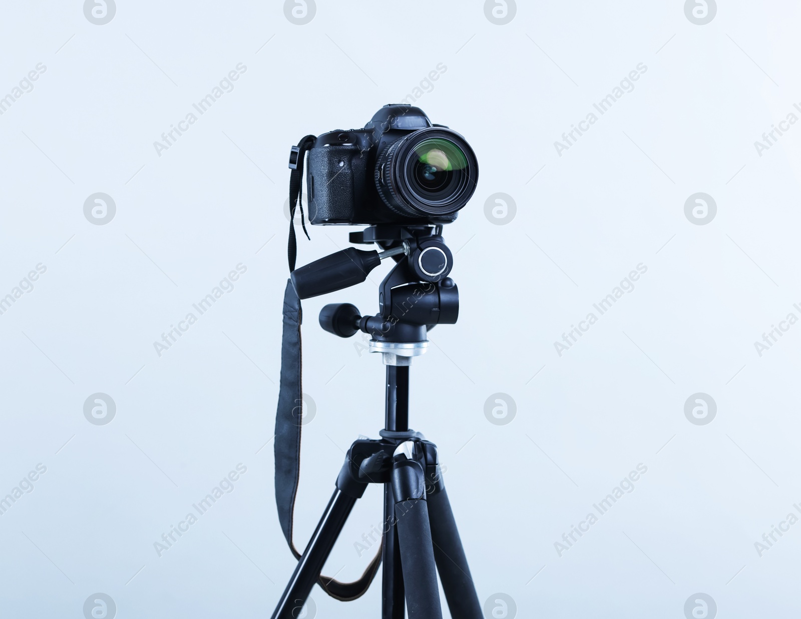 Modern professional video camera on light grey background Photo of Modern professional video camera on light grey background