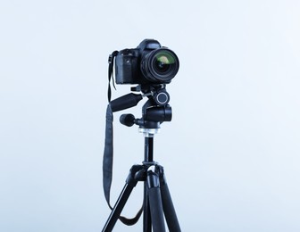 Photo of Modern professional video camera on light grey background