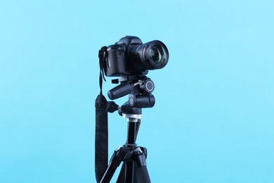 Photo of Professional video camera on light blue background