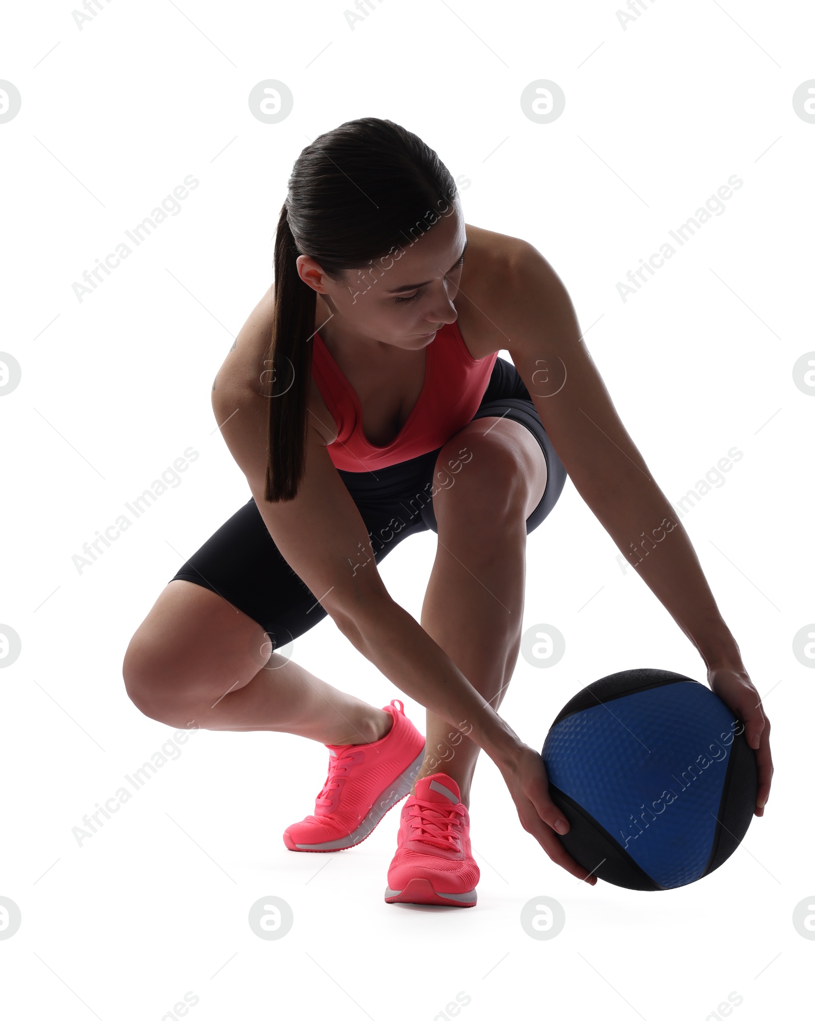 Athletic woman exercising with medicine ball on white background Photo of Athletic woman exercising with medicine ball on white background