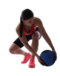 Photo of Athletic woman exercising with medicine ball on white background