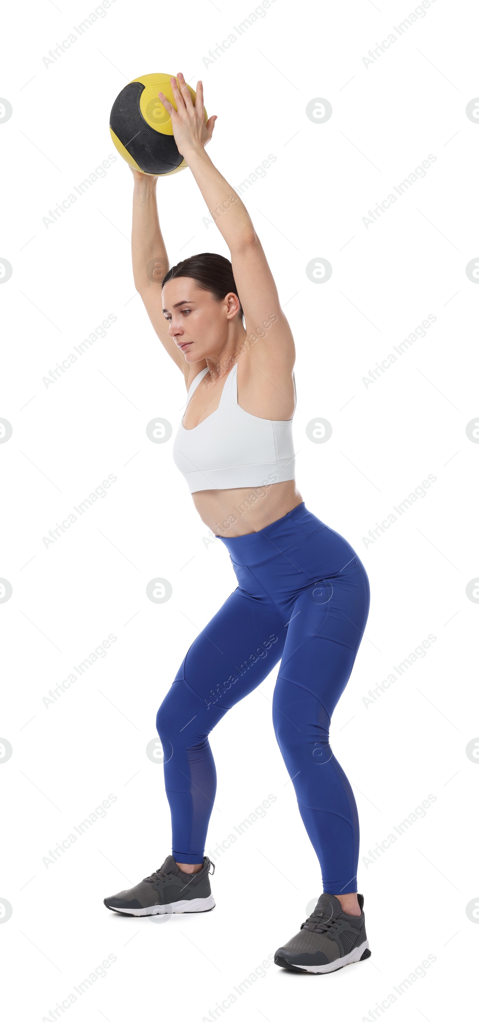 Athletic woman exercising with medicine ball on white background Photo of Athletic woman exercising with medicine ball on white background