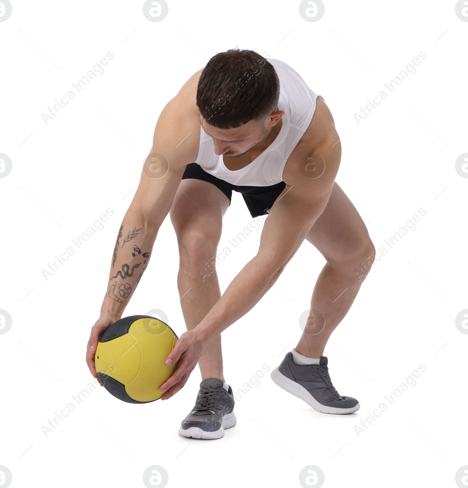 Man exercising with medicine ball on white background Photo of Man exercising with medicine ball on white background