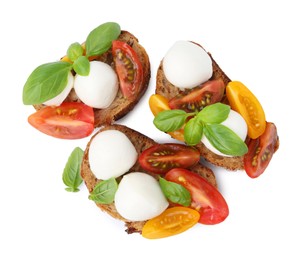 Photo of Tasty sandwiches with mozzarella cheese, tomatoes and basil isolated on white, top view