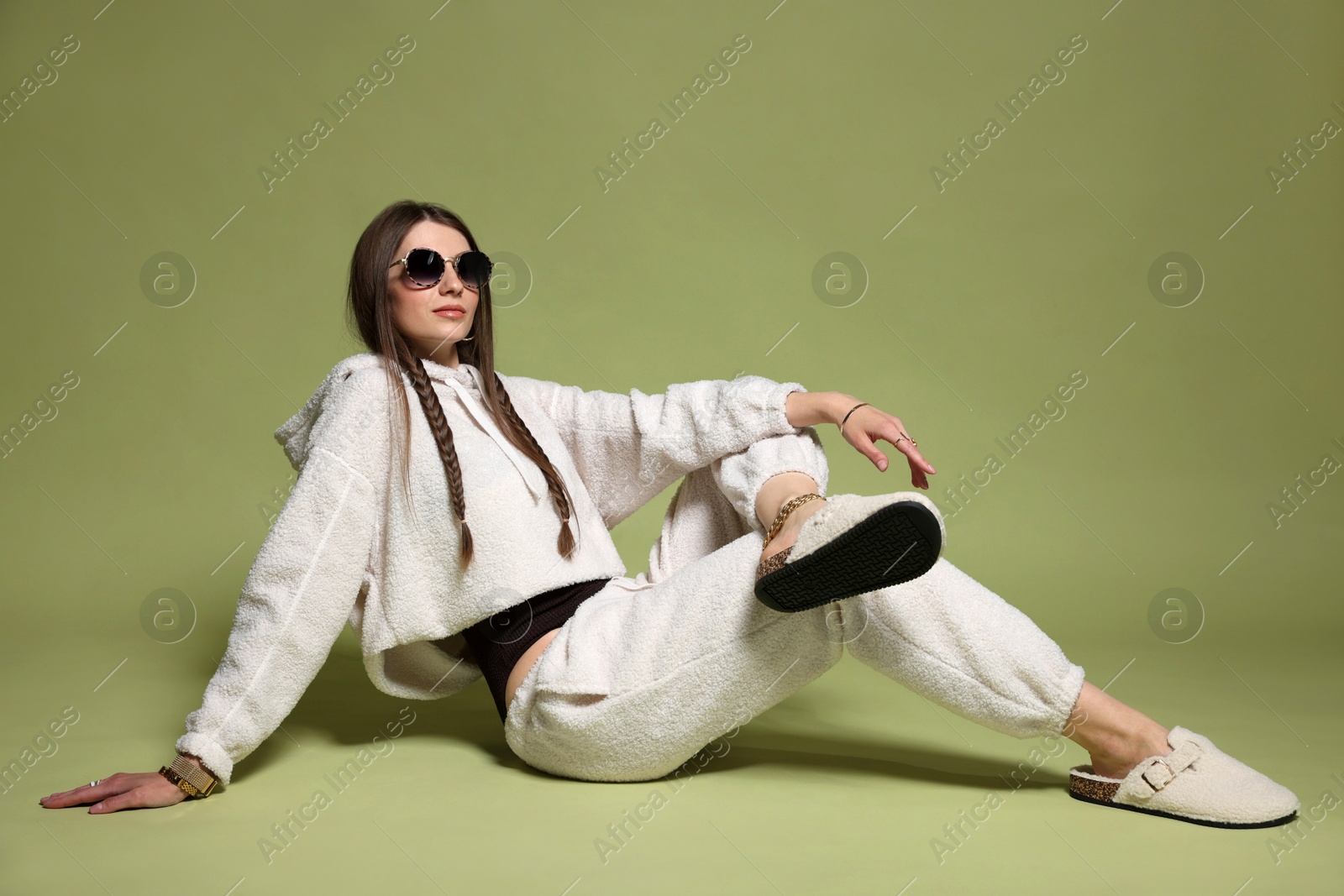 Fashionable portrait of beautiful woman in stylish outfit on green background Photo of Fashionable portrait of beautiful woman in stylish outfit on green background