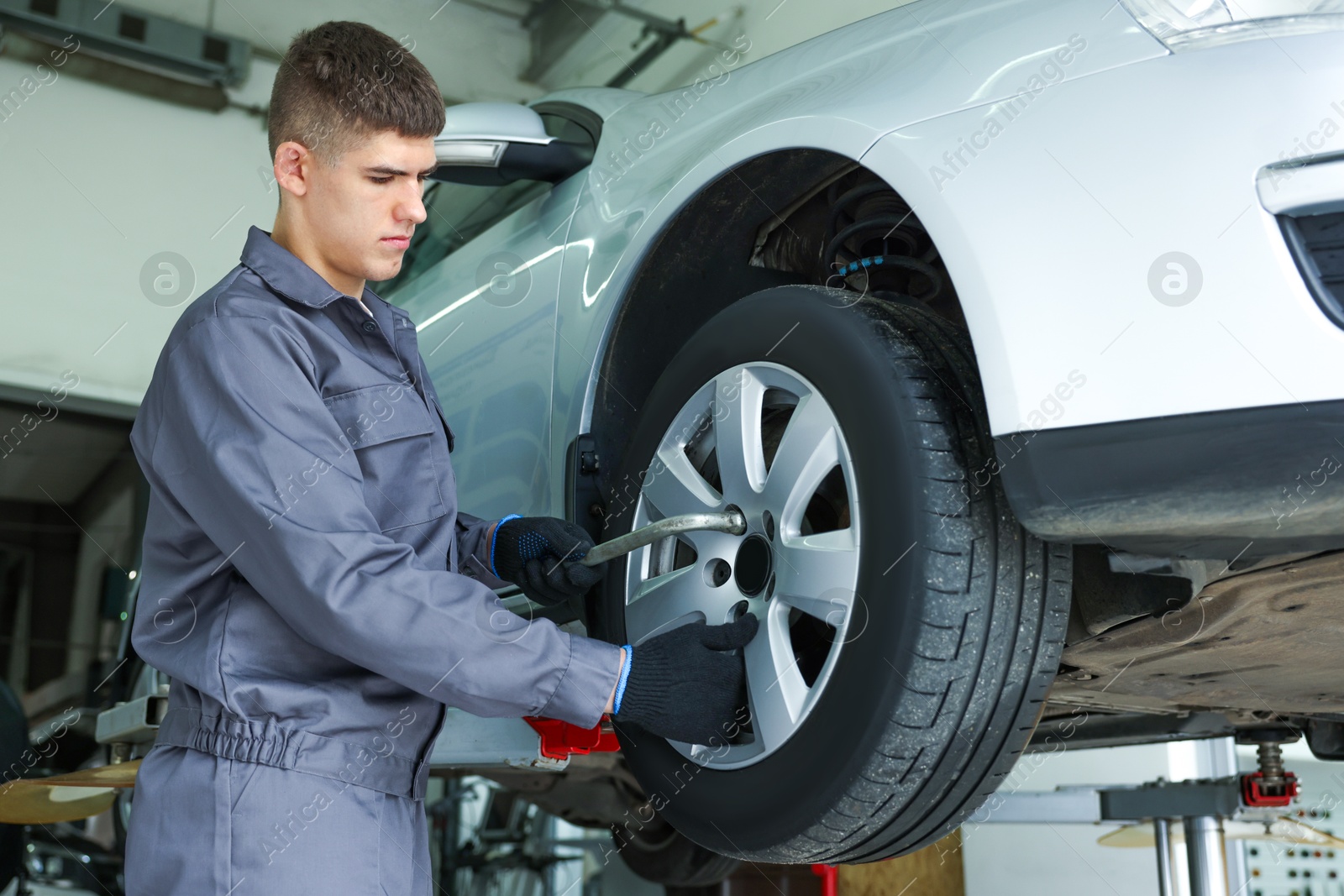 Photo of Professional mechanic changing tire at car service