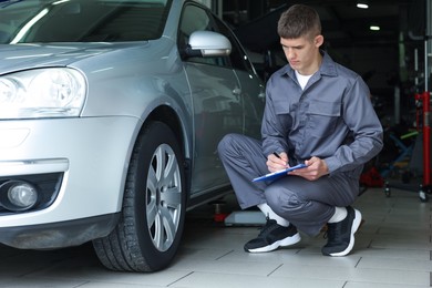 Photo of Mechanic checking tire after change at car service