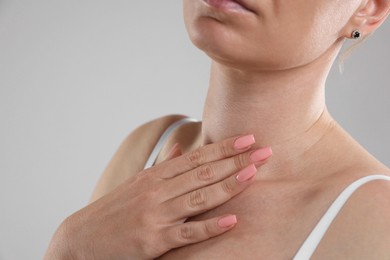 Photo of Woman with moles on her body against light background, closeup. Space for text