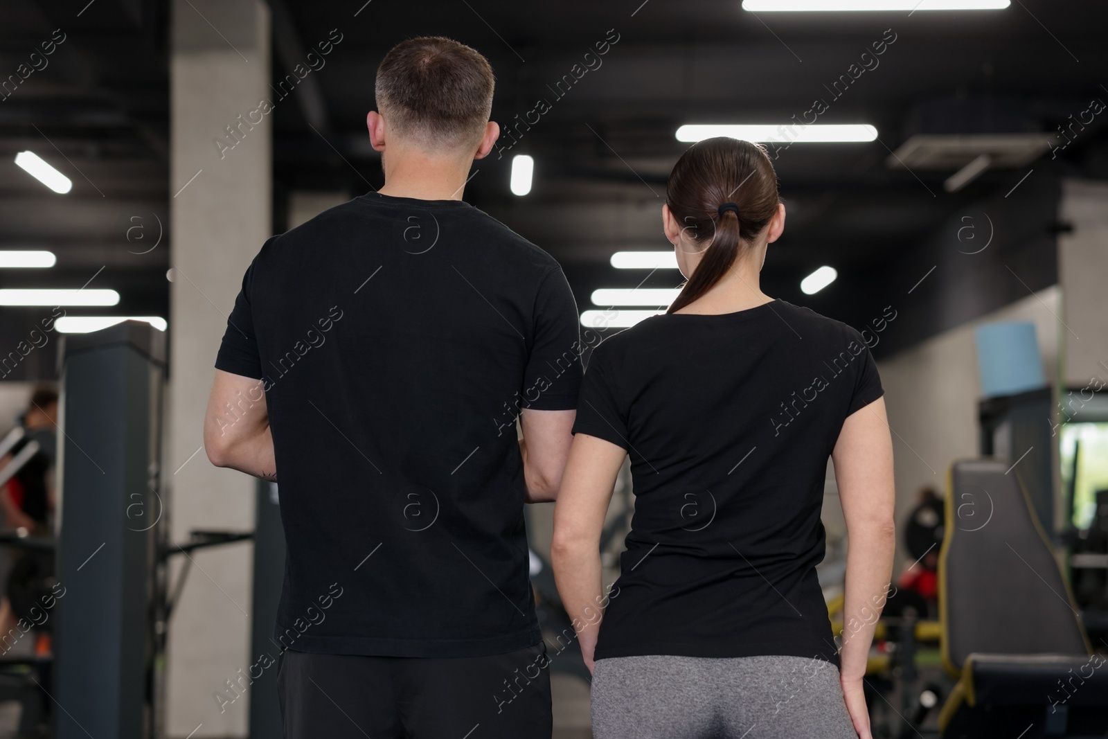 Personal trainers in sport center, back view Photo of Personal trainers in sport center, back view