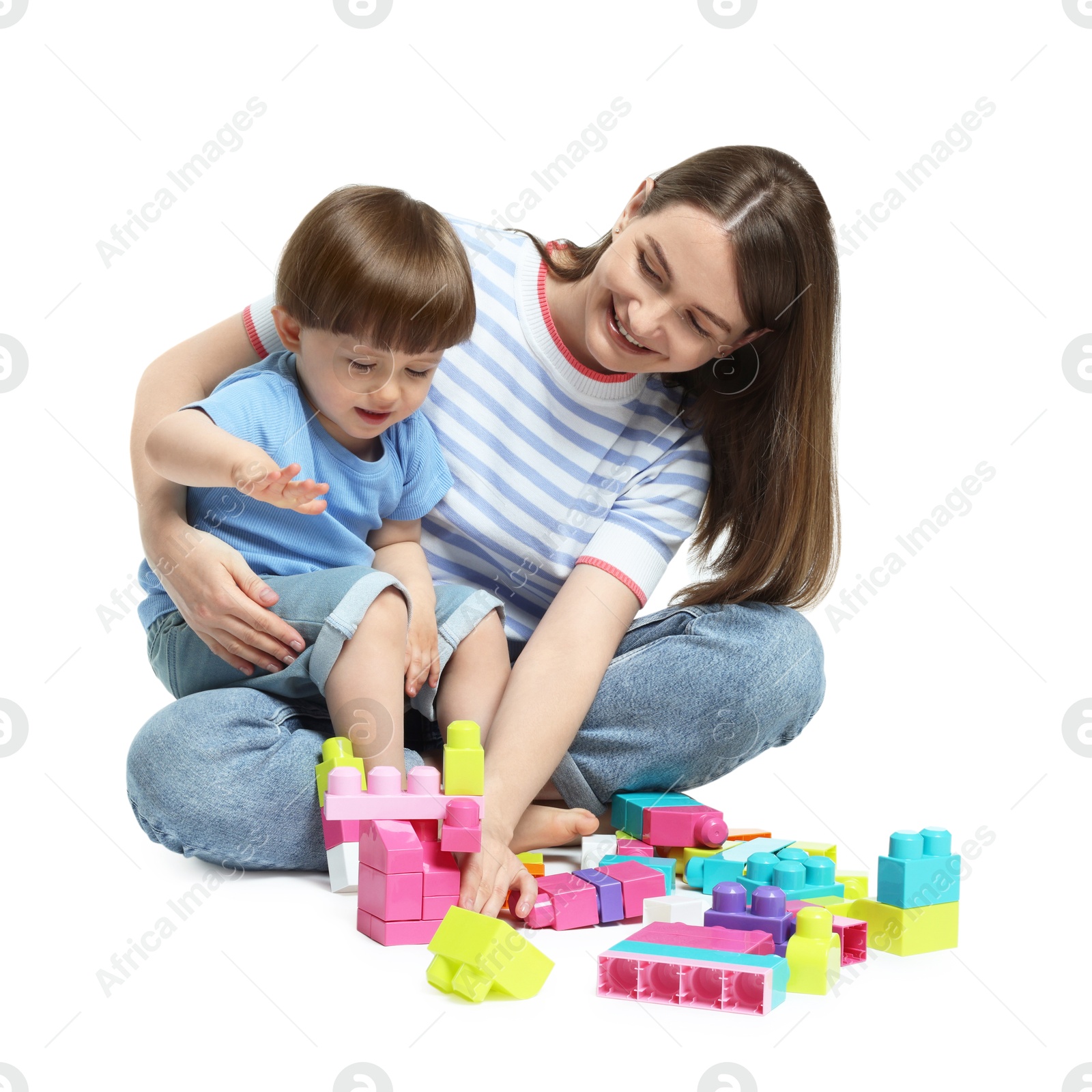 Mother and son playing with building bricks on white background Photo of Mother and son playing with building bricks on white background