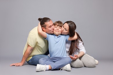 Photo of Portrait of happy family on grey background