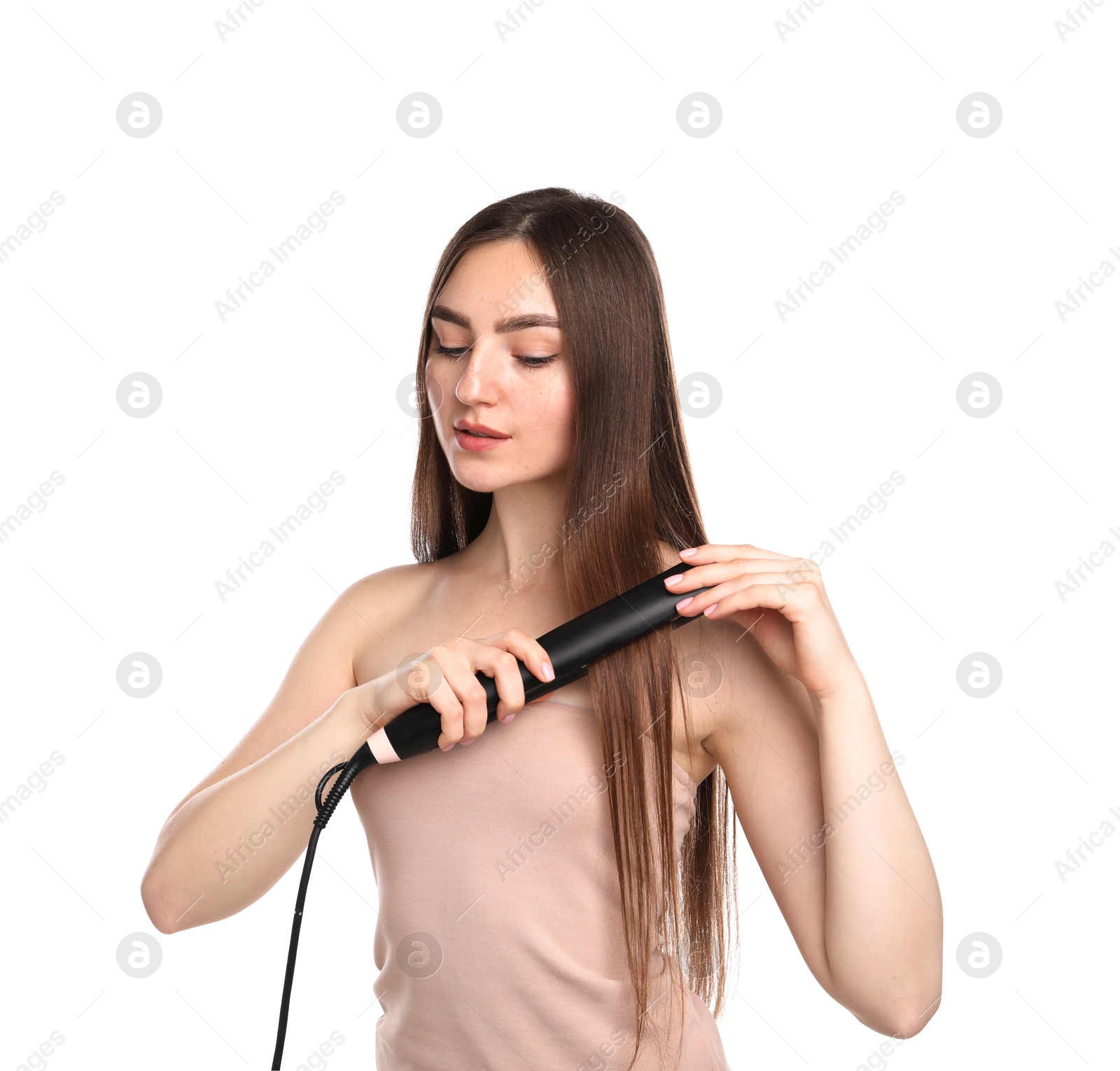 Woman straightening her beautiful hair on white background Photo of Woman straightening her beautiful hair on white background