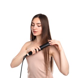 Photo of Woman straightening her beautiful hair on white background