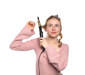 Photo of Woman curling her hair on white background