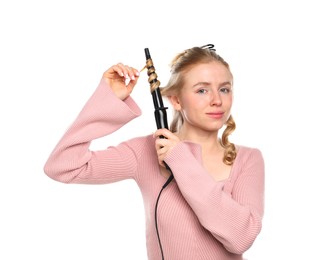 Photo of Woman curling her hair on white background