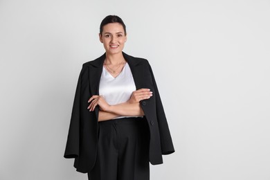 Photo of Confident business woman in suit on light background