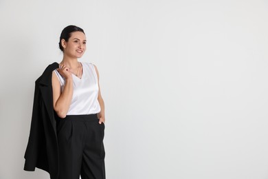 Photo of Confident business woman in suit on light background. Space for text