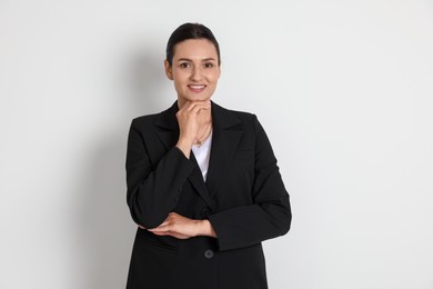 Photo of Confident business woman in suit on light background
