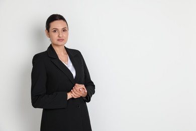 Photo of Confident business woman in suit on light background. Space for text