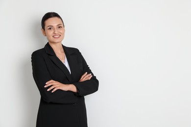 Photo of Confident business woman in suit on light background. Space for text