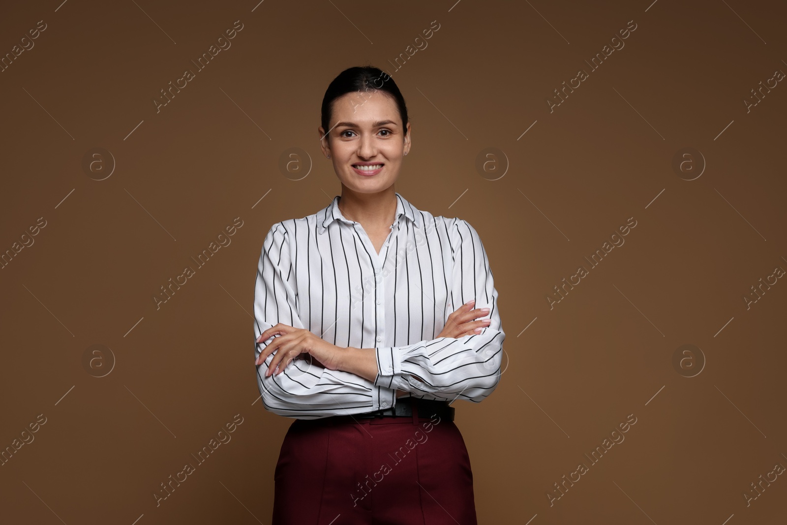Portrait of confident business woman on brown background Photo of Portrait of confident business woman on brown background