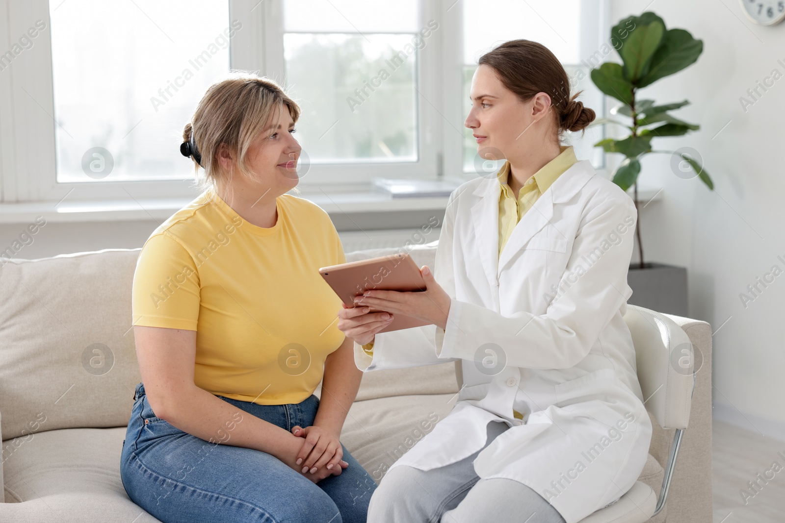 Weight loss. Nutritionist consulting overweight woman in clinic Photo of Weight loss. Nutritionist consulting overweight woman in clinic