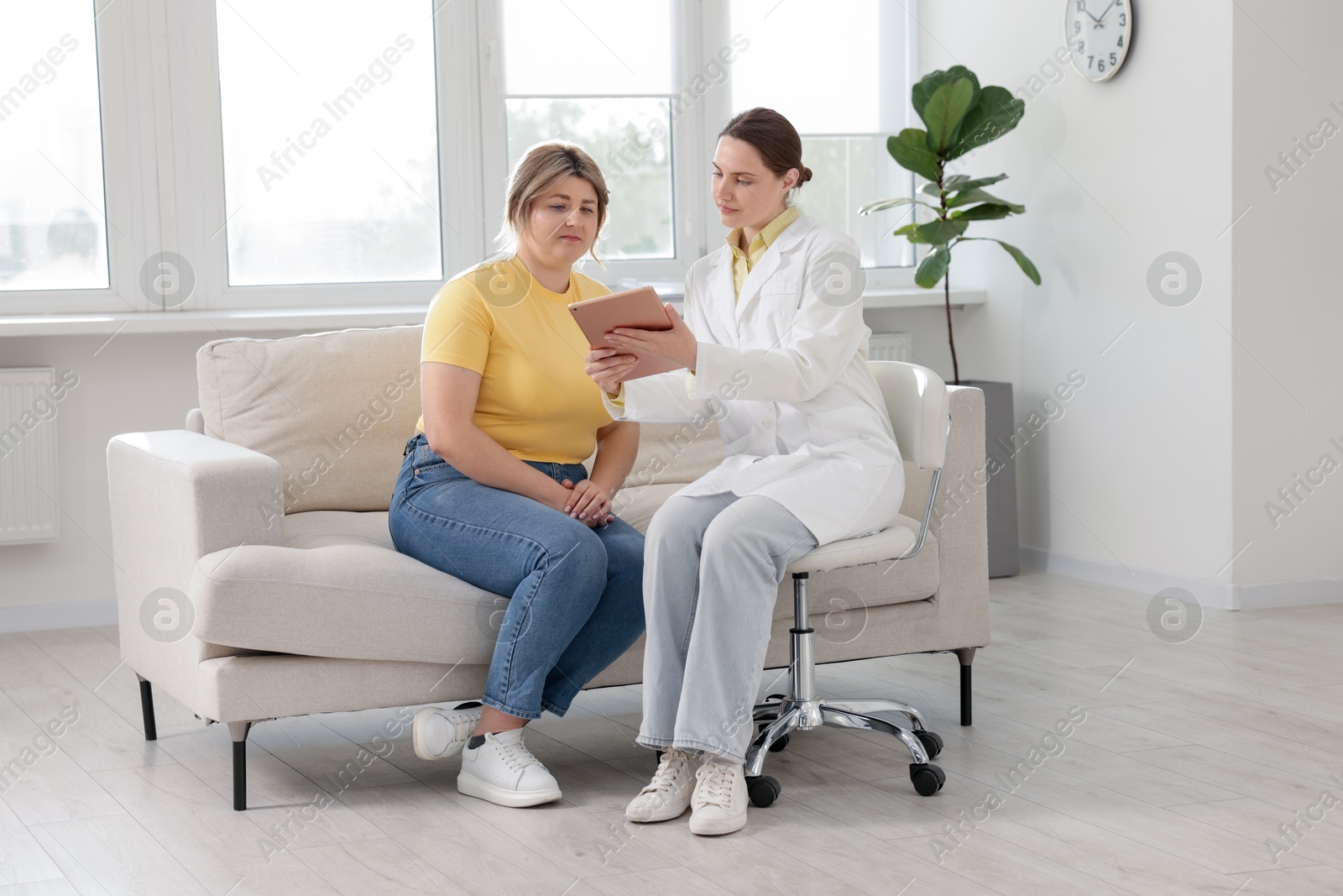 Weight loss. Nutritionist consulting overweight woman in clinic Photo of Weight loss. Nutritionist consulting overweight woman in clinic